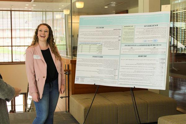 YHC student with presentation board